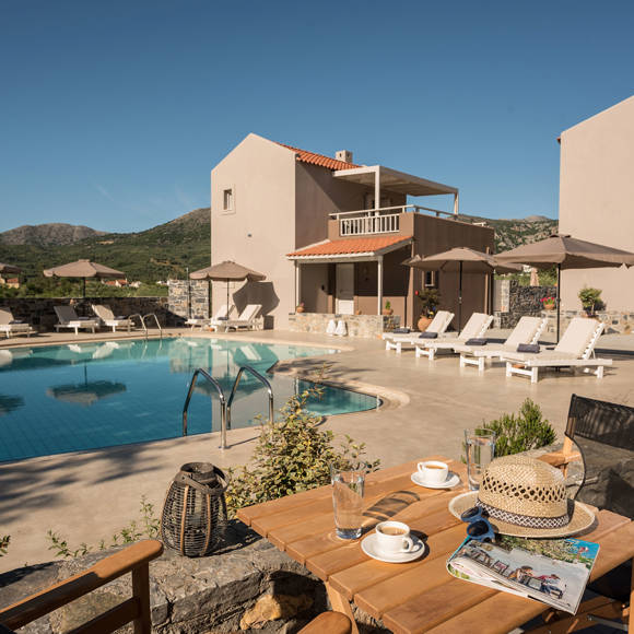 Relaxing pool area at Avdou Collection by Trend Hotels with mountain views and sun loungers in Crete