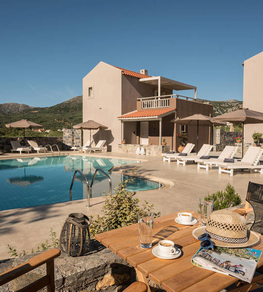 Relaxing pool area at Avdou Collection by Trend Hotels with mountain views and sun loungers in Crete