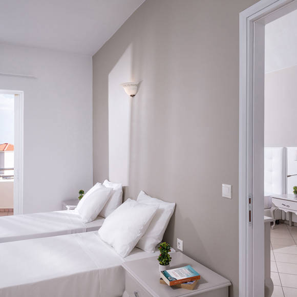 Bright twin bedroom at Dore Hotel by Trend Hotels in Chania with modern decor and soft natural light