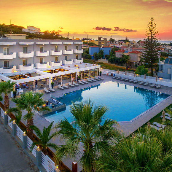 Aerial view of Dore Hotel by Trend Hotels in Chania with large outdoor pool and sunset backdrop